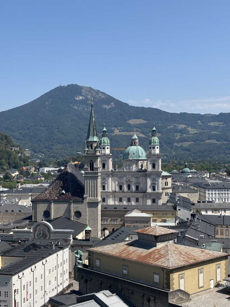 Salzburg's Old Town from above. With the mound of Gaisberg Mountain in the background and the St Peter's Abbey in the centre.