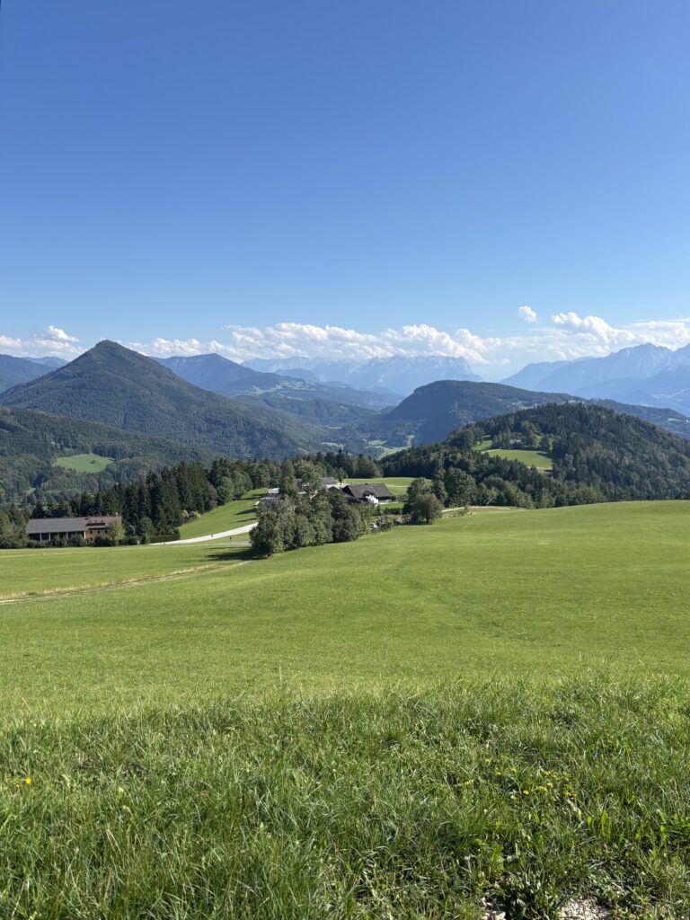 Viewpoint on the Gaisberg Mountain Hike in Salzburg overlooking mountains and green meadows.